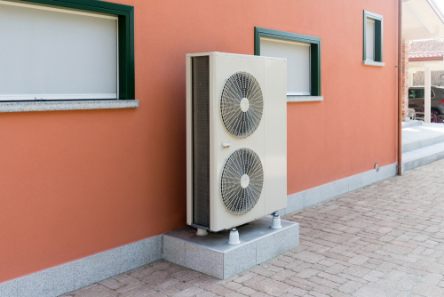 A heat pump exterior unit mounted outside a home.