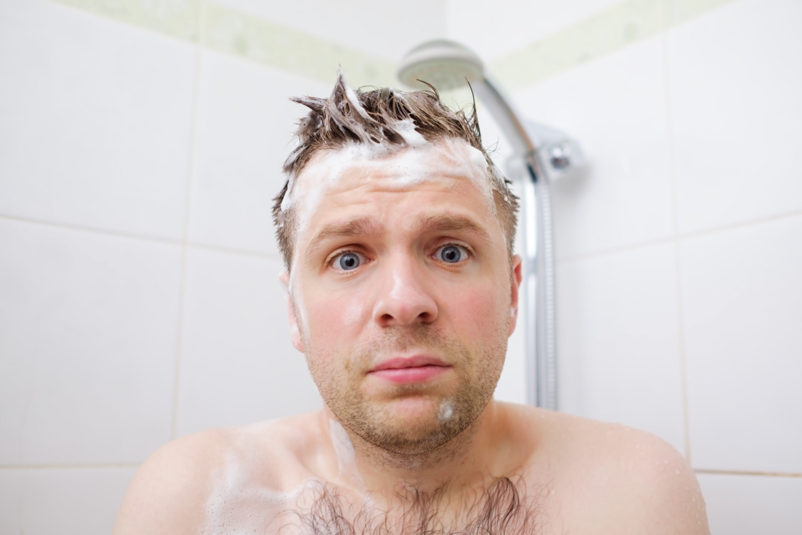 man with shampoo on him in shower