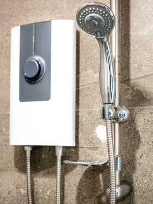 A tankless water heater mounted inside of a shower.
