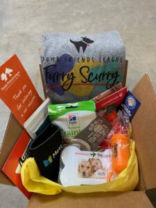 box with dog toys and treats