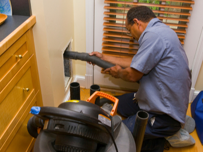 A man performing a duct cleaning