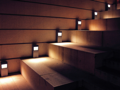 Modern wooden staircase illuminated with halogen lights