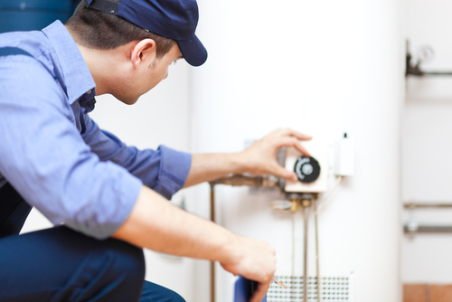 Applewood technician adjusting the temperature on a water heater.