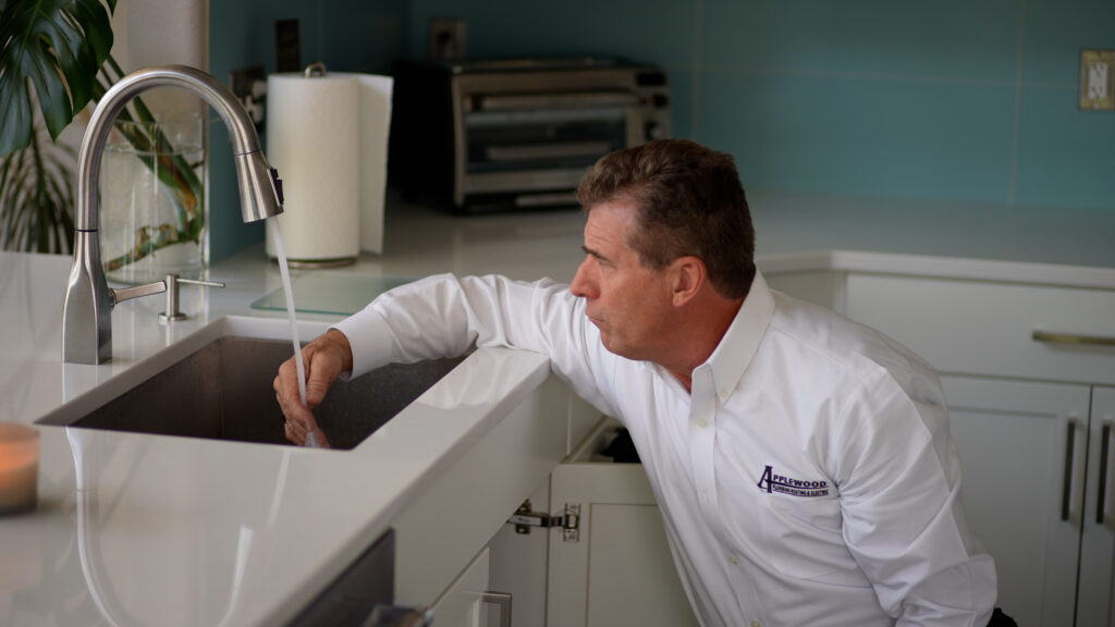 applewood worker testing sink water pressure