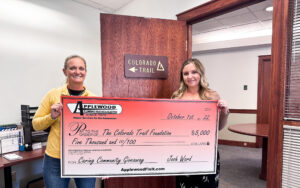 applewood employees holding a large applewood check