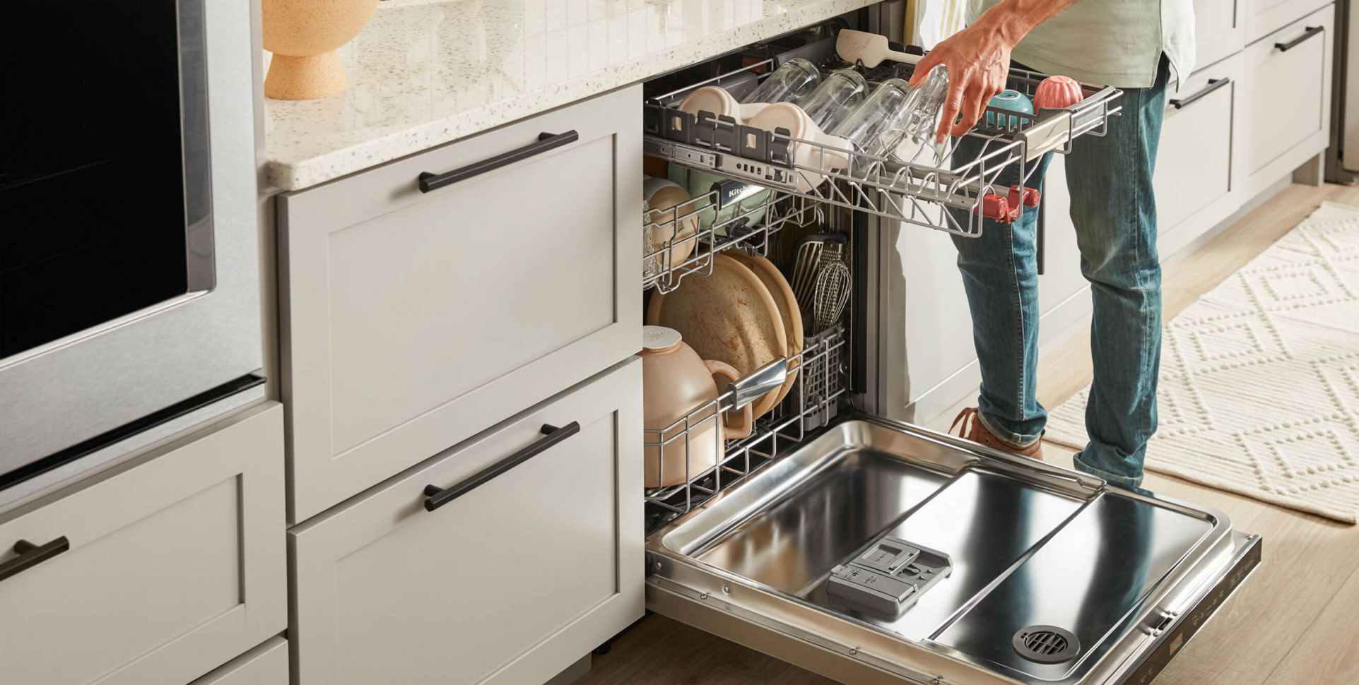 person putting dishes in a dishwasher