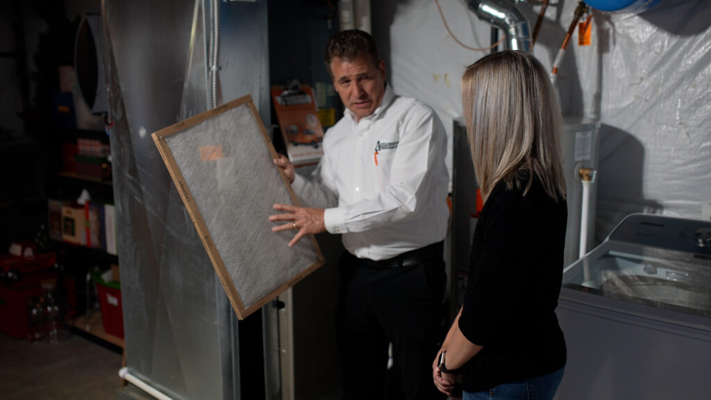 An HVAC technician explains the benefits of upgrading your furnace filter.