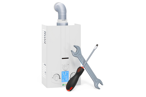 A tankless water heater installation with a wrench and screwdriver next to it.