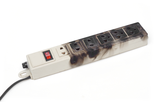 An outlet strip with burn marks from an electrical fire.