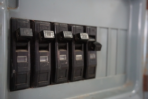 Close up view of circuit breaker switches with one tripped.