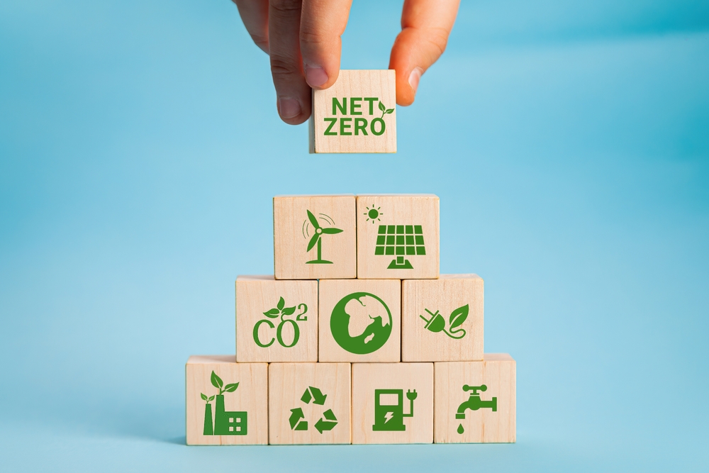 hand putting a cube down that says net zero