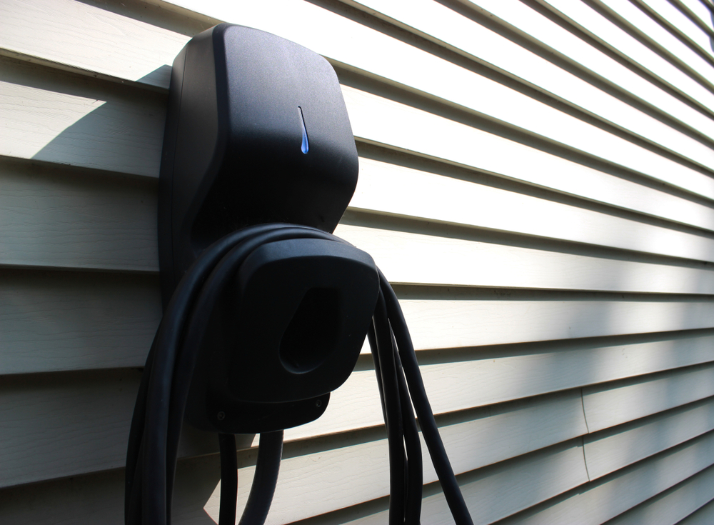 A Level 2 EV charger mounted on a home exterior.
