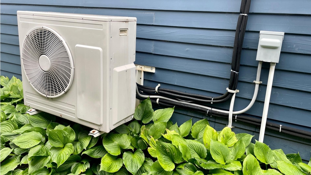 A heat pump compressor on the exterior of a home.