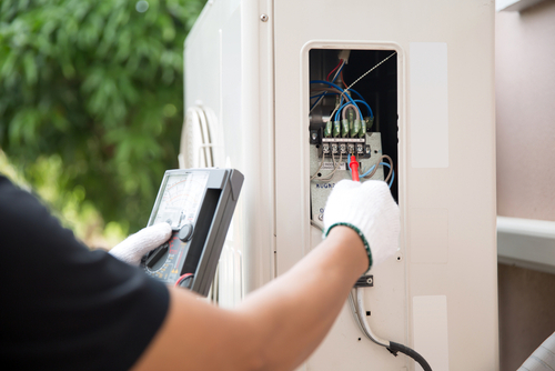 A technician performs heat pump repair.