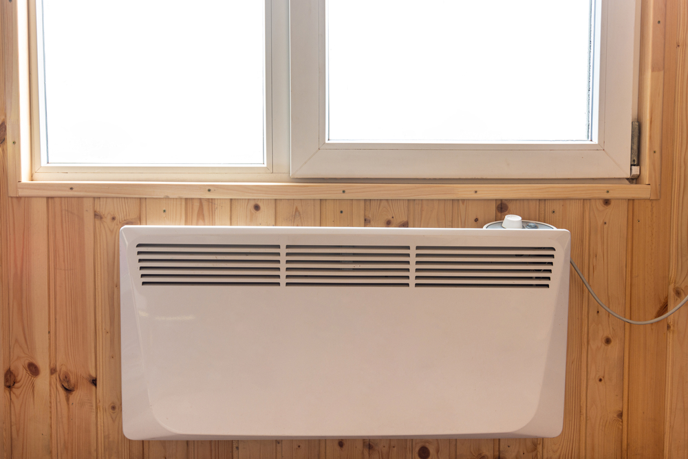 An electric radiator mounted beneath a window.