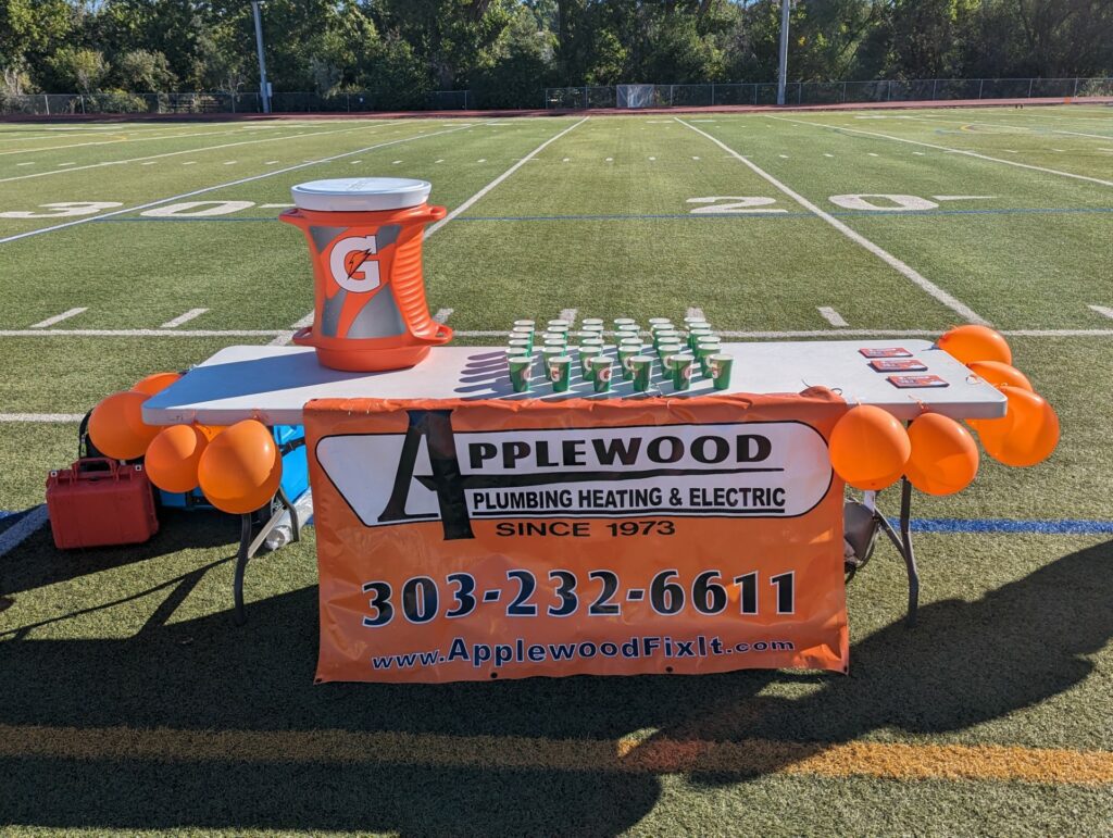 Table with drinks for marathon and Applewood banner.