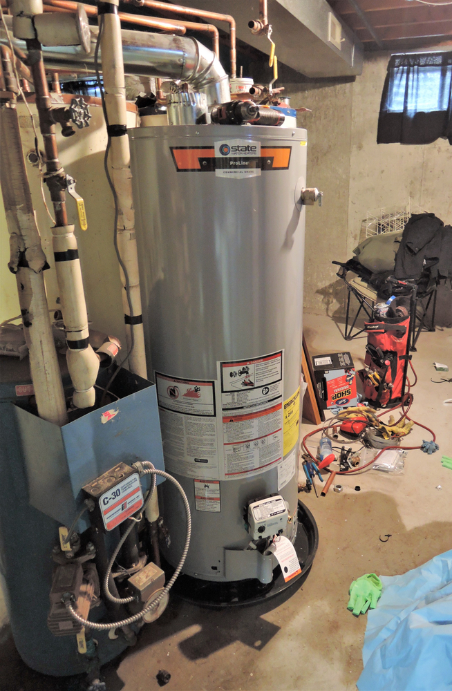 A home water heater leaks from the bottom.