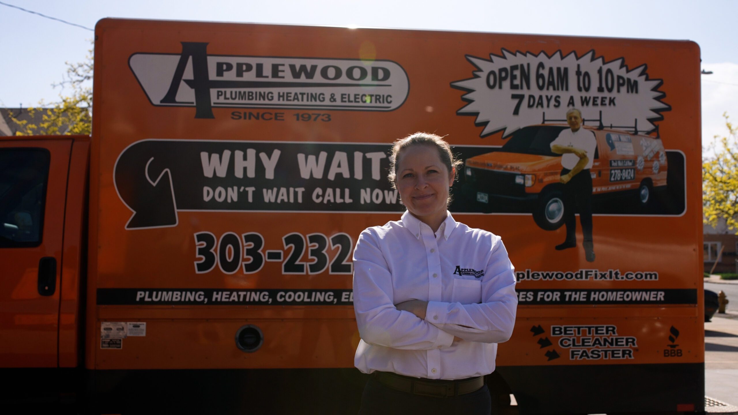 applewood employee standing in front of orange truck