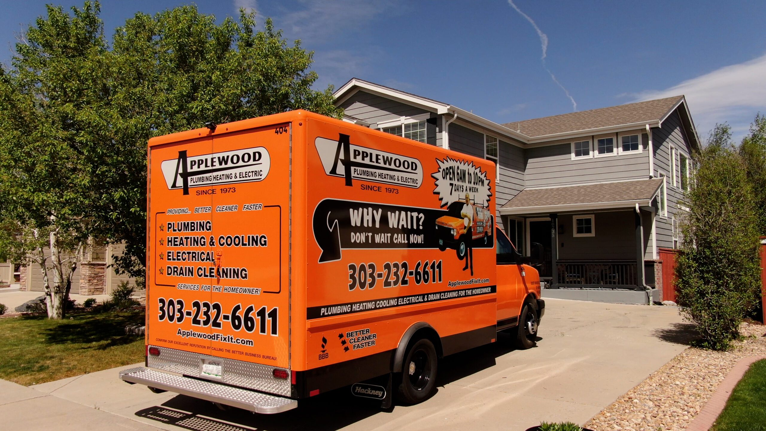 applewood orange truck parked outside of house in driveway