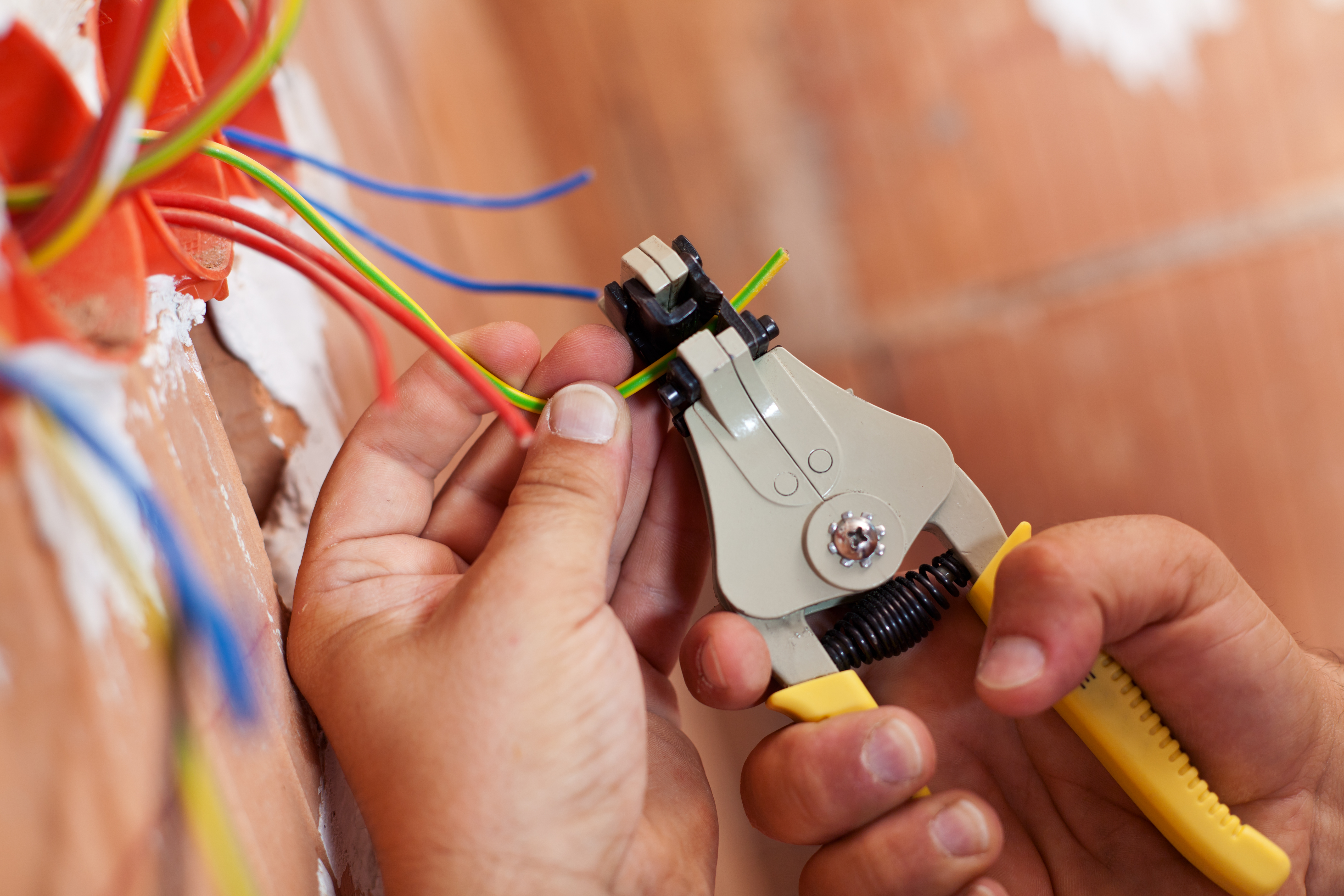 hand with electrical pliers