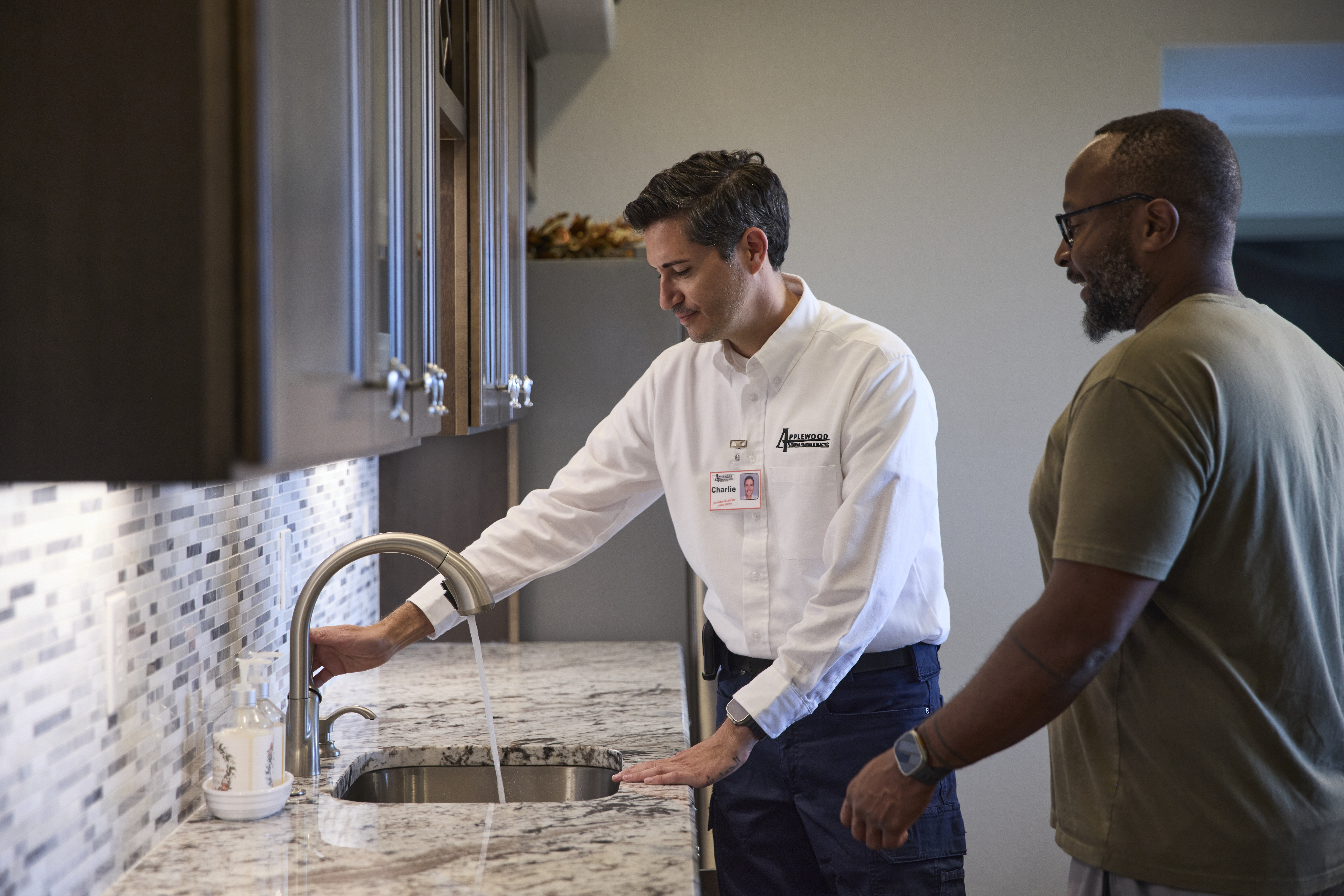 applewood tech working on a kitchen facet