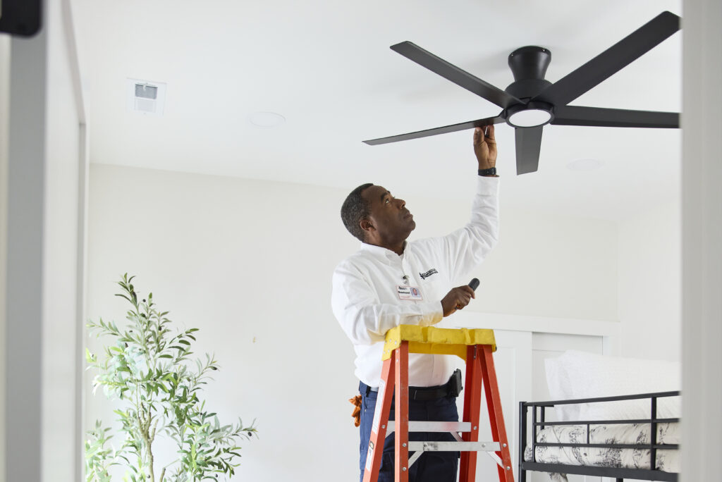 man working on a ceiling fan